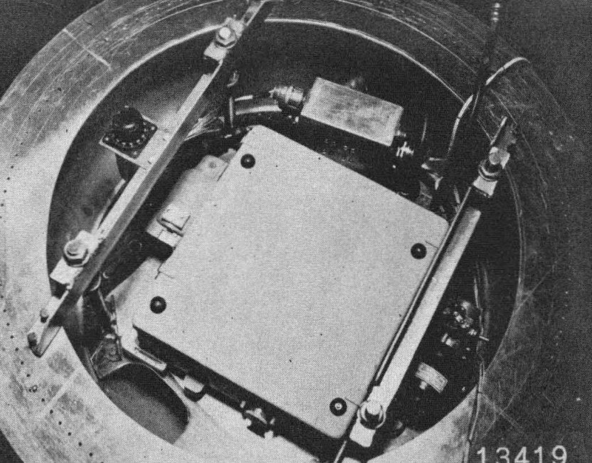 A top view of the camera, with magazine removed. showing the top of the camera and some of its auxiliary equipment.