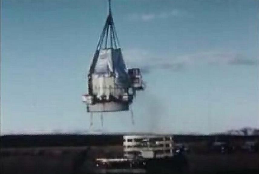 View of the gondola being lifted by the balloon. Bellow is the flat bed truck used as launch vehicle