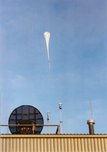 CCN counter balloon package shortly after launch at Laramie, Wyoming, on January 22, 1997. The balloon launch building is in the forground.