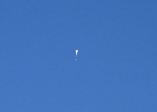 A view of the ascending balloon from the ground.