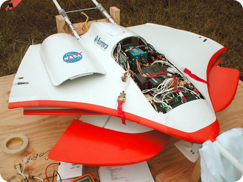 Cover removed to show the interior of the Mars Eagle 50% scale high-altitude drop model. The flight computer is the blue box visible toward the back of the opening. Wings are shown in their stowed position, under the fuselage.