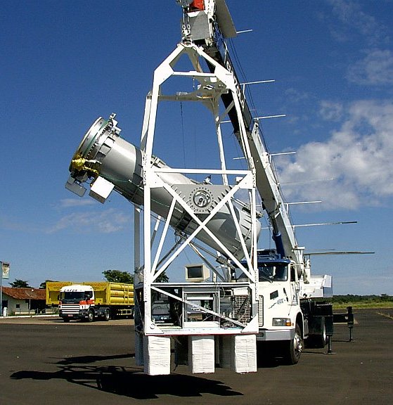 The MASCO telescope is hung up by a crane during a hang test in Nova Ponte Airport