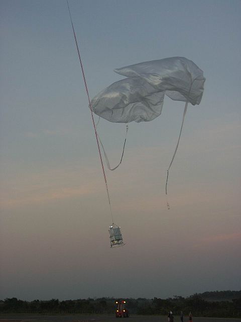 The main balloon pull off the payload and the auxiliary balloons are cut loose