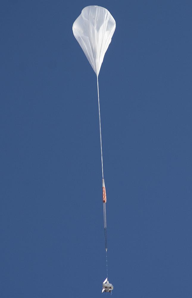 Initial ascent phase. A large portion of the balloon is left unfilled so it can expand as it ascends into the thinner air of the stratosphere. (Photo by Carlye Calvin, UCAR)