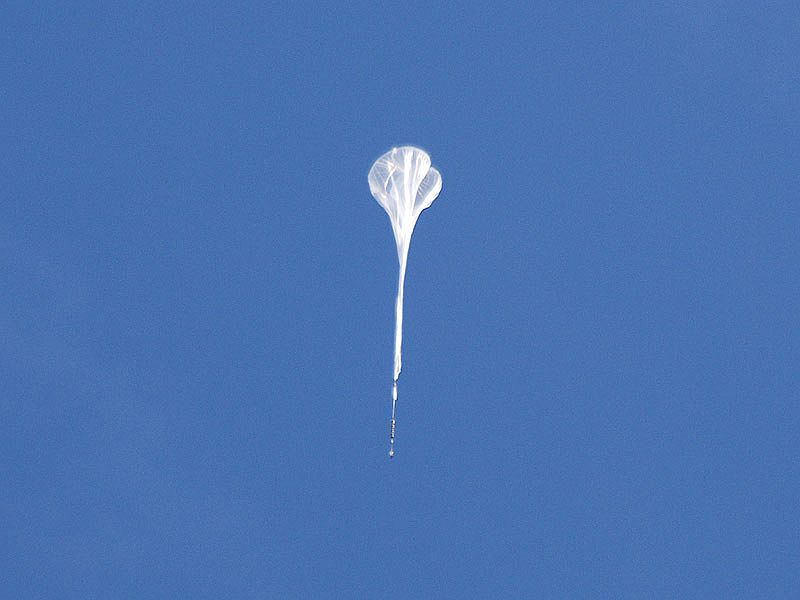 The DUSTER balloon flying over Longyearbyen a few minutes after launch.	(Picture: Mr Petter Dragøy / Andoya Rocket Range)