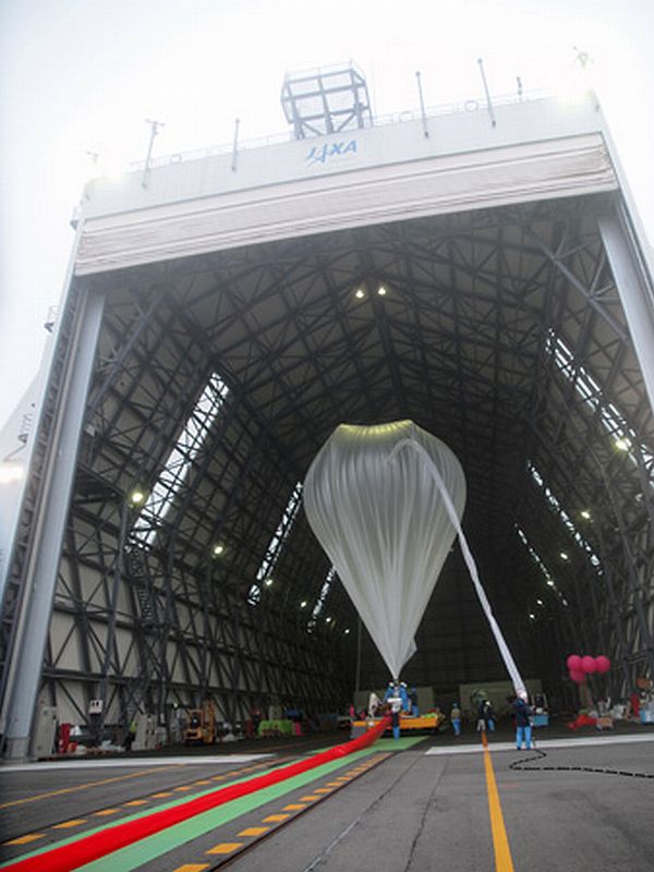 The balloon being inflated inside the hanger