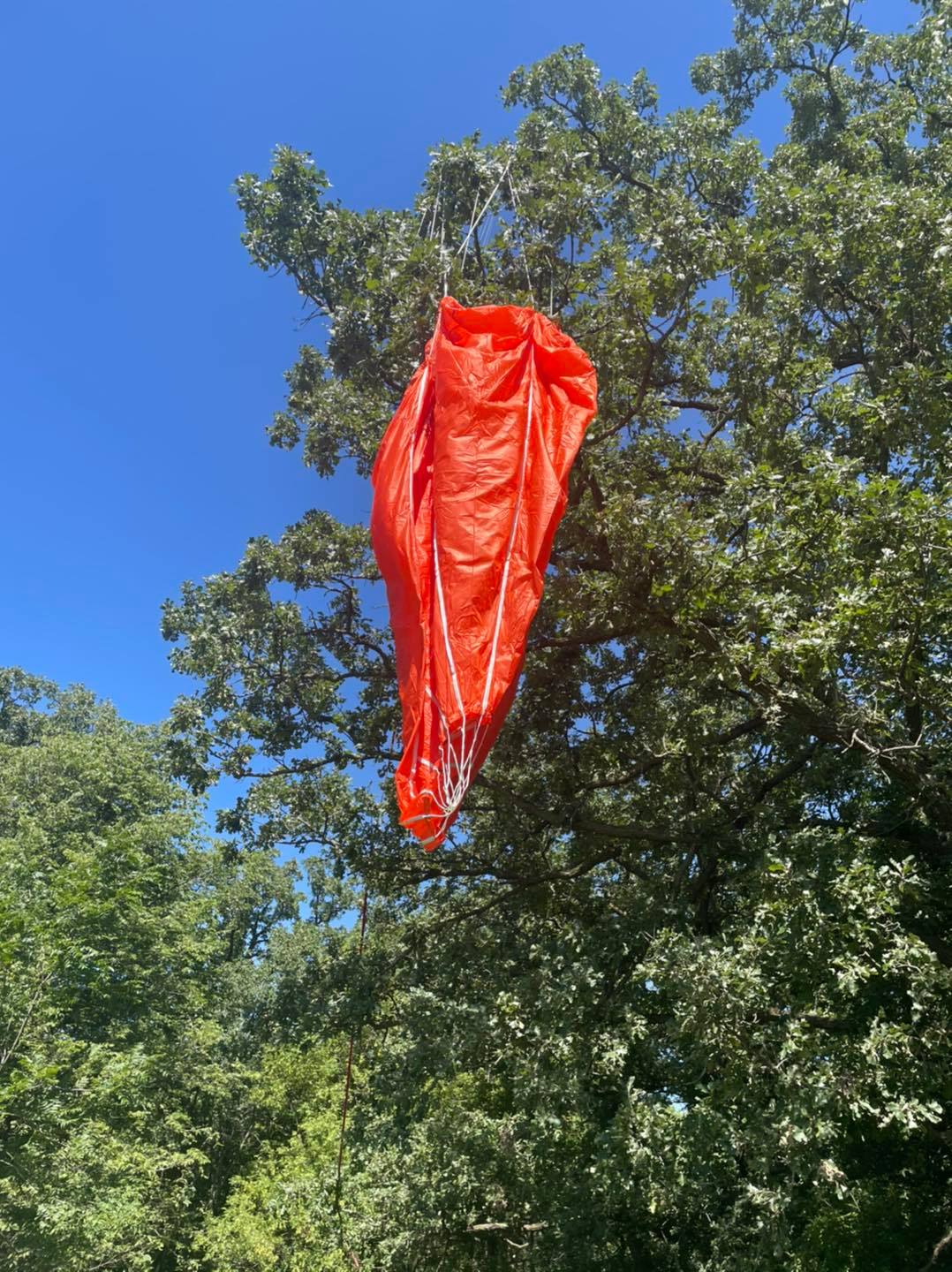 The parachute hanging from a tree in the farm on which the payload landed (Picture: Oak Grove Farm Shelters)