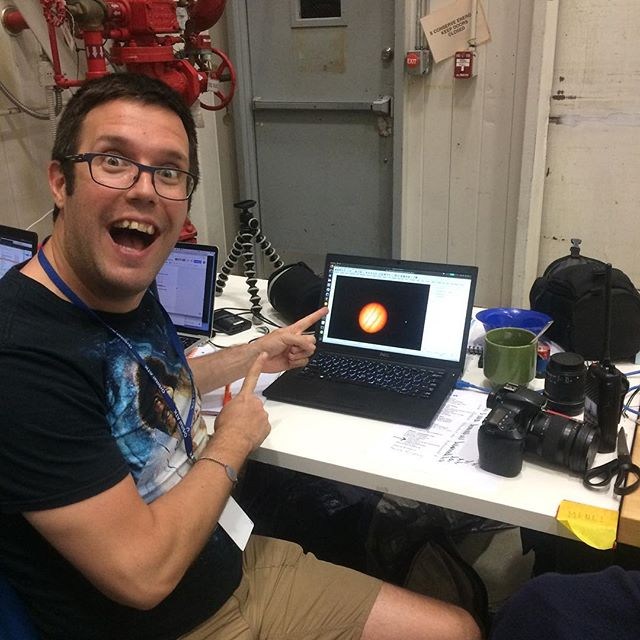One of the members of the scientific team exultant looking at the image of Jupiter obtained by the telescope in flight (Image: SuperBIT instagram account)